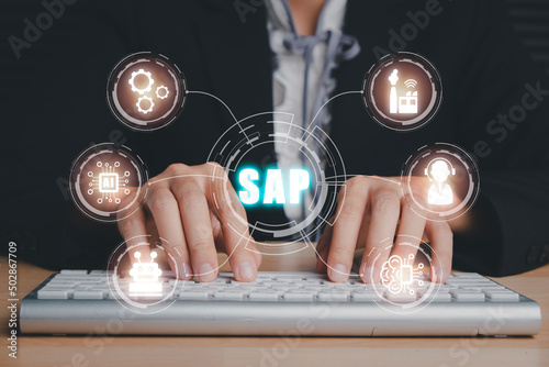 SAP - Business process automation software and management software (SAP), Person hand typing on keyboard with ERP enterprise resources planning system concept on virtual screen.