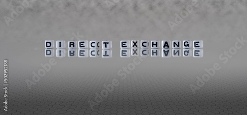 direct exchange word or concept represented by black and white letter cubes on a grey horizon background stretching to infinity