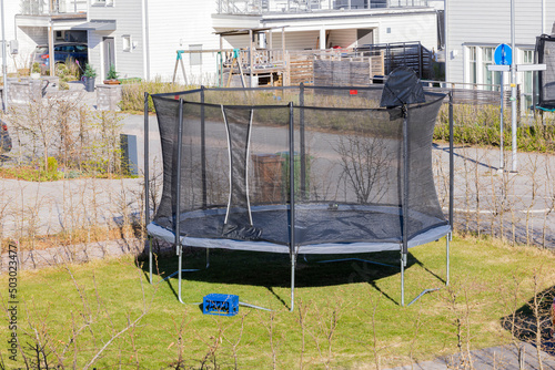 Beautiful view of trampoline with protective net installed in yard. Active recreation concept. Sweden.