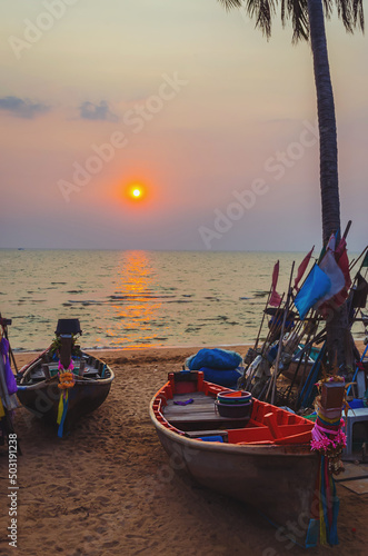 Traditional long tail boat on Pattaya beach at sunset, Thailand