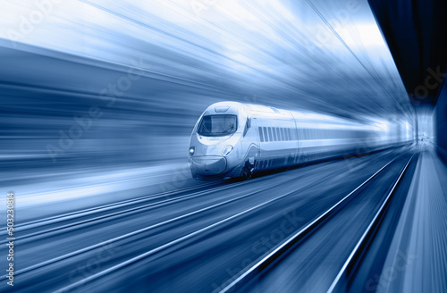 Blue high speed train runs on rail tracks - The train is going too fast as a result the air pressure is causing too much heat at the front