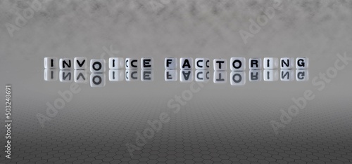 invoice factoring word or concept represented by black and white letter cubes on a grey horizon background stretching to infinity