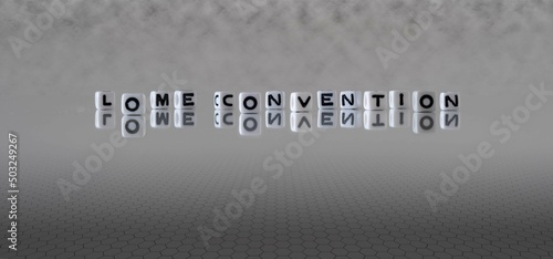 lome convention word or concept represented by black and white letter cubes on a grey horizon background stretching to infinity