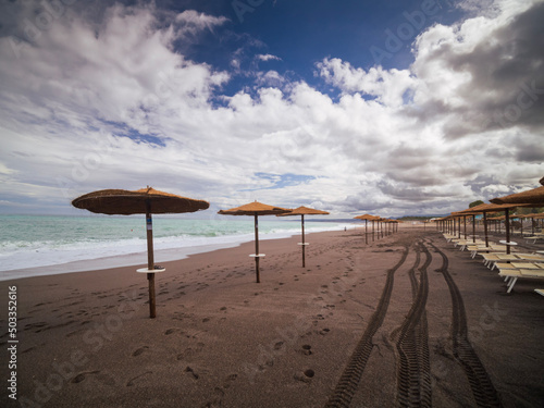 beach with umbrellas in Giardini Naxos 