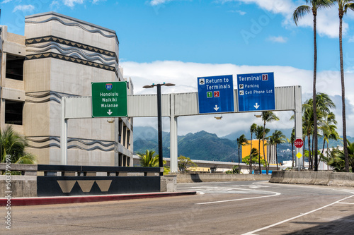 Road signs above the road on International Airport in Honolulu, Hawaii