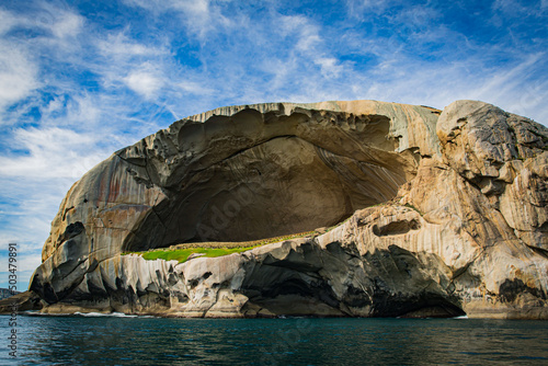 Skull Rock stone island seascape in Cruising tour view in the Bass Strait at Wilson Promontory Victoria Australia, blue sky and blue sea