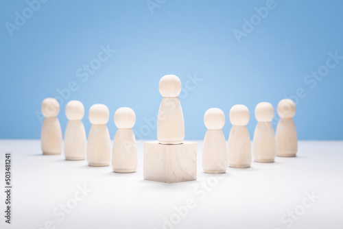 Leadership, wooden business team with one person standing out from the crowd