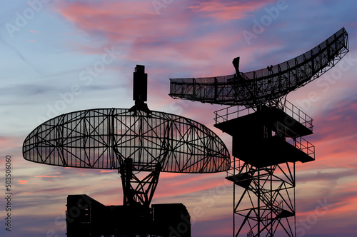 Air defense radars of military mobile anti aircraft systems, modern army industry on the background of the sunset orange sky, Russia