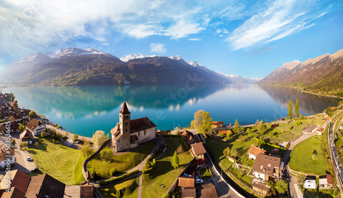 Stunning idylic nature scenery of lake Brienz with turquoise waters. Switzerland, Bern canton. Aerial view with little church in the morning light