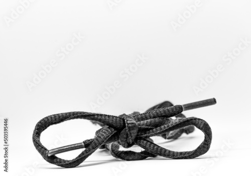 Closeup shot of a knot from gray shoelaces isolated on a white background