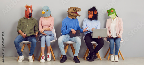 Funny people with animal faces talking while sitting in row in waiting room. Company employees or job applicants in silly masks sitting in line, chatting, using laptops, reading and discussing news
