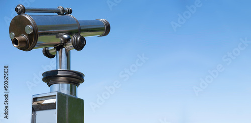 Tourist Coin-operated monocular observation telescope for a closer look at the environment. Blue sky, widescreen image, space for text or design