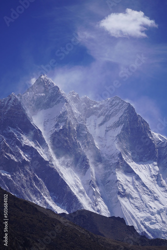 Vertical shot of Lhotse mountain in Asia covered in snow in blue sky background
