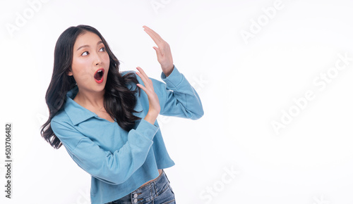 Excited asian woman casual holding hand shocked surprised sale product with copy space over white background. Cheerful young girl emotion amazed screaming wow something on isolated. Shopping online.