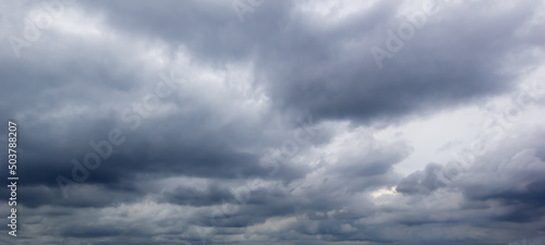 The dark sky with heavy clouds converging and a violent storm before the rain.Bad weather sky..