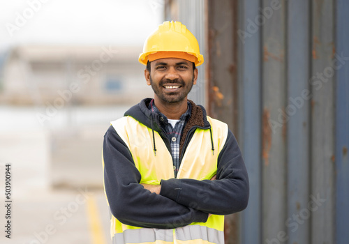 indian engineer man working in logistics at container port - migrant worker man concept -