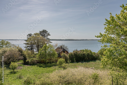 rural landscape and a sommer house along the Iseford in Denmark