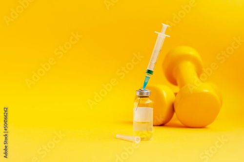 syringe is stuck in jar, there are dumbbells on yellow background next to it, a horizontal photo, copy space. concept of doping in sports, steroids, testosterone and other drugs prohibited in sports.
