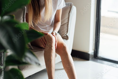 Woman at home massaging tired painful and spider varicose veins. Healthcare problem, thrombophlebitis issue. laser surgery recovery and prevention, Compression Stockings Thigh