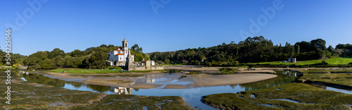 panorama view of the Parish Church of our Lady of Sorrows in Barro on the Barro River at low tide