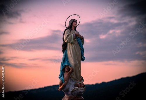 Bella escultura de la Virgen María al amanecer