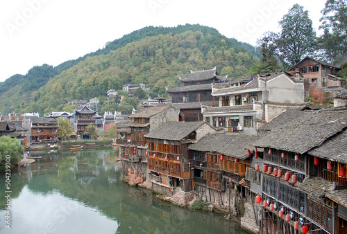 Fenghuang, Hunan Province, China: Old wooden riverside houses in Fenghuang ancient town. The town is built on the Tuojiang River and is home to Miao and Tujia minority peoples.