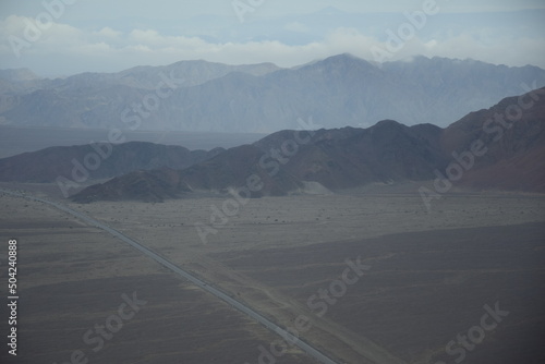 View from under the wing of an airplane on the surroundings of the Nazca. It is the largest town in Nazca Province