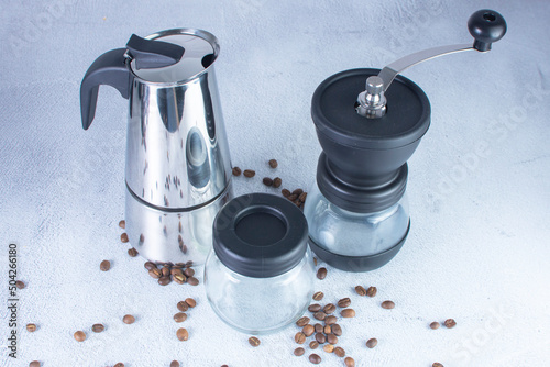 coffee maker and coffee grinder on gray background