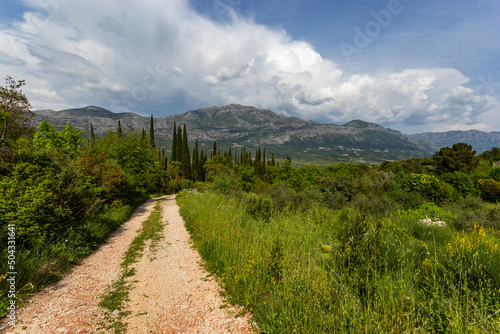 Road to valley. Mountain landscape with dramatic sky. A storm is coming from the mountains.