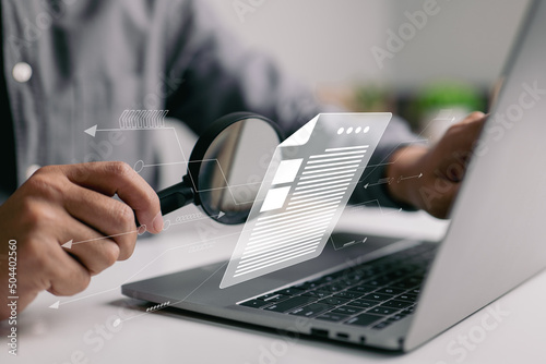 Man inspecting paperwork with magnifier. A business analysis concept.