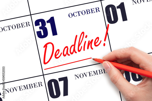 Hand drawing red line and writing the text Deadline on calendar date October 31. Deadline word written on calendar