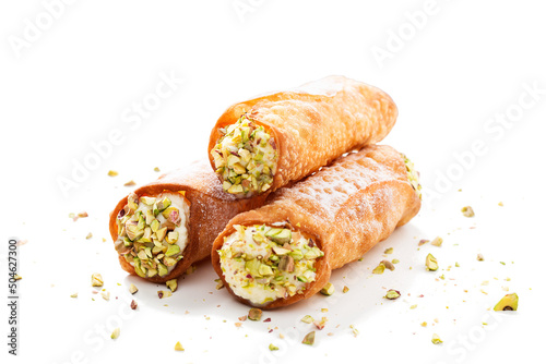 Sweet homemade cannoli stuffed with ricotta cheese and pistachio. Sicilian dessert. Italian pastry. isolated on a white background