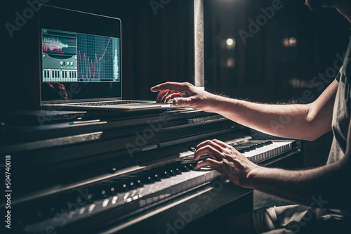 A man composer, producer, arranger, songwriter, musician hands arranging music.