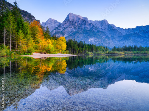 Mountains and reflections on the surface of the water. Mountain lake and forest. Landscape in the high mountain region. Natural landscape.