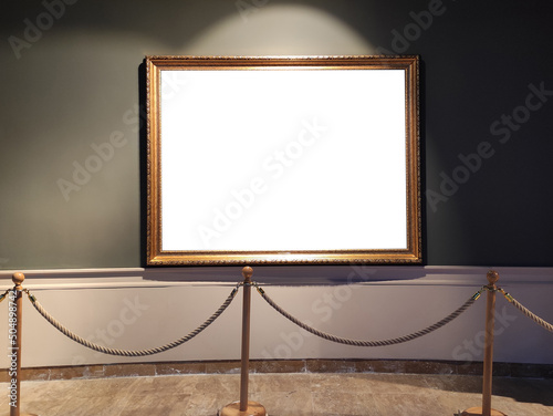 Blank golden picture frame on museum wall