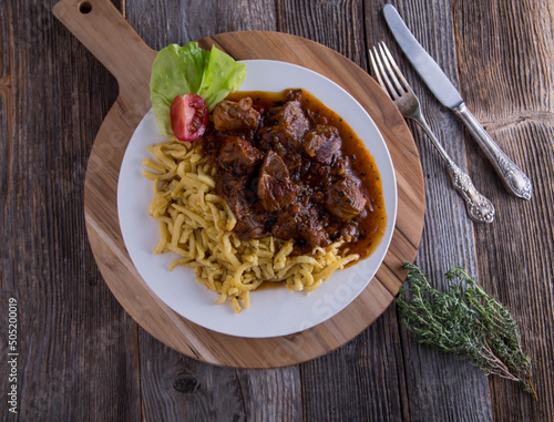 Goulash with spaetzle noodles on a plate