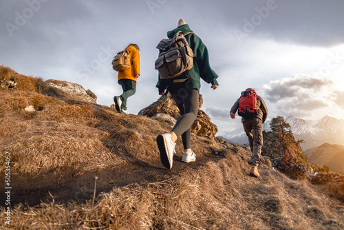 Young hikers with small backpacks walks in mountains