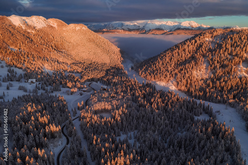 Winter sunrise in the mountains with low fog in the valley. 