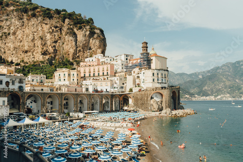 Panoramic view of Atrani, the city on the Amalfi coast, with beach, parasols, and people, enjoying a rest on the beach