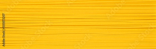 Yellow long raw spaghetti background. egg or wheat noodles