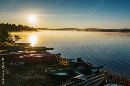 Southern Urals, Ural Mountains. Zyuratkul National Park, Zyuratkul Lake. Fishing boats on the lake shore. Aerial view.
