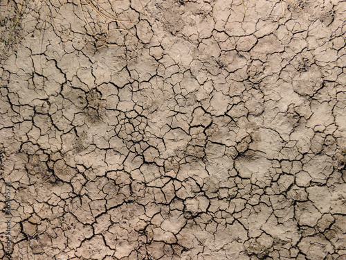 Dry river bed. Empty dry river bed with cracked ground. Global warming concept. Flat desert plain landscape, dried up reservoir, barren earth shattering