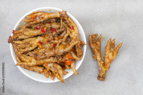  South African township delicacy, cooked chicken feet or walkie talkies with onion and sauce 