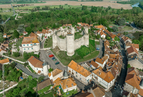 Aerial view of Billy castle in Central France with donjon, four semi circle towers and fortified gate house on a hilltop