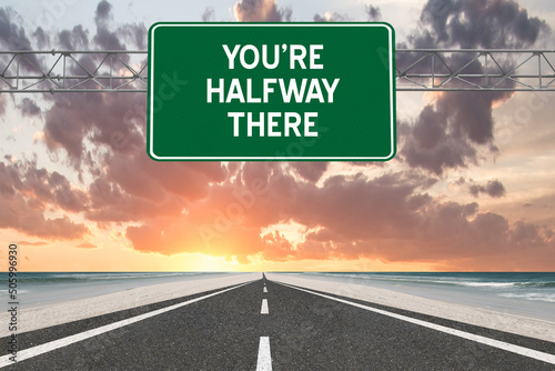 You're Halfway There motivational highway sign.