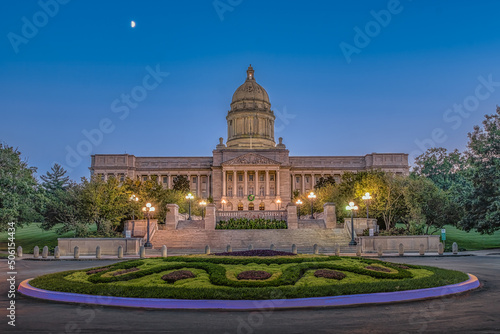 Illuminated Kentucky State Capitol at dusk with warm lights illuminating this great capitol with a blue sky on a warm summer evening in Frankfort, KY.