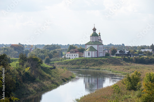 The Church of Elijah the Prophet was built in 1744 and is located in the bend of the Kamenka River, opposite the Suzdal Kremlin. Religion concept. Suzdal, Vladimir region, Russia - SEPTEMBER 12, 2021