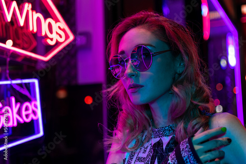 portrait of beautiful woman in neon light. night city street shot 