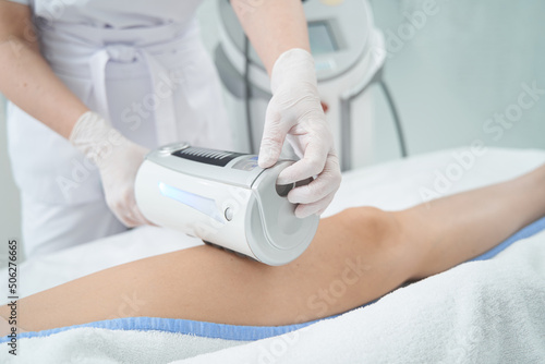Person conducting therapy on patient leg