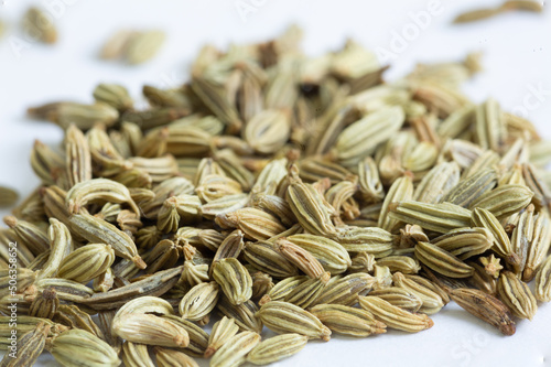 A close up macro photo of a pile of whole fennel seeds his popular spice is used in many cuisines from European cuisine to Indian Cuisine, isolated on a white background high quality photo